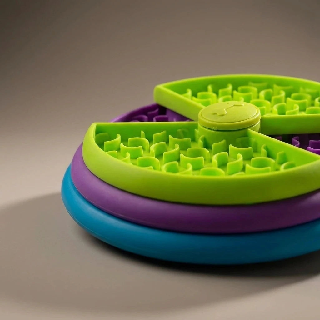 Pet slow food bowl anti choking cat bowl dog basin puzzle feeder healthy pet rotating game board | The second frame of the same studio session as the previous image: same piece, same warm-grey sweep, same single key light.